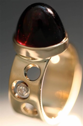 Dark red cabochon ring with circular cutout details